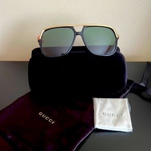 Unisex Gucci black plastic with gold metal rim & temples